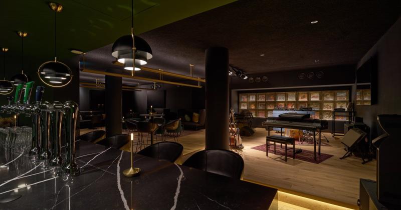 dark club room with stage and bar in the darkest club inn Amsterdam - Eden hotel- apto architects